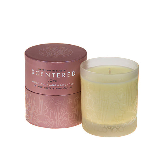 Love home candle next to its packaging, Essential oil Rose, Patchouli, Cedarwood Candle for Hormone balance.