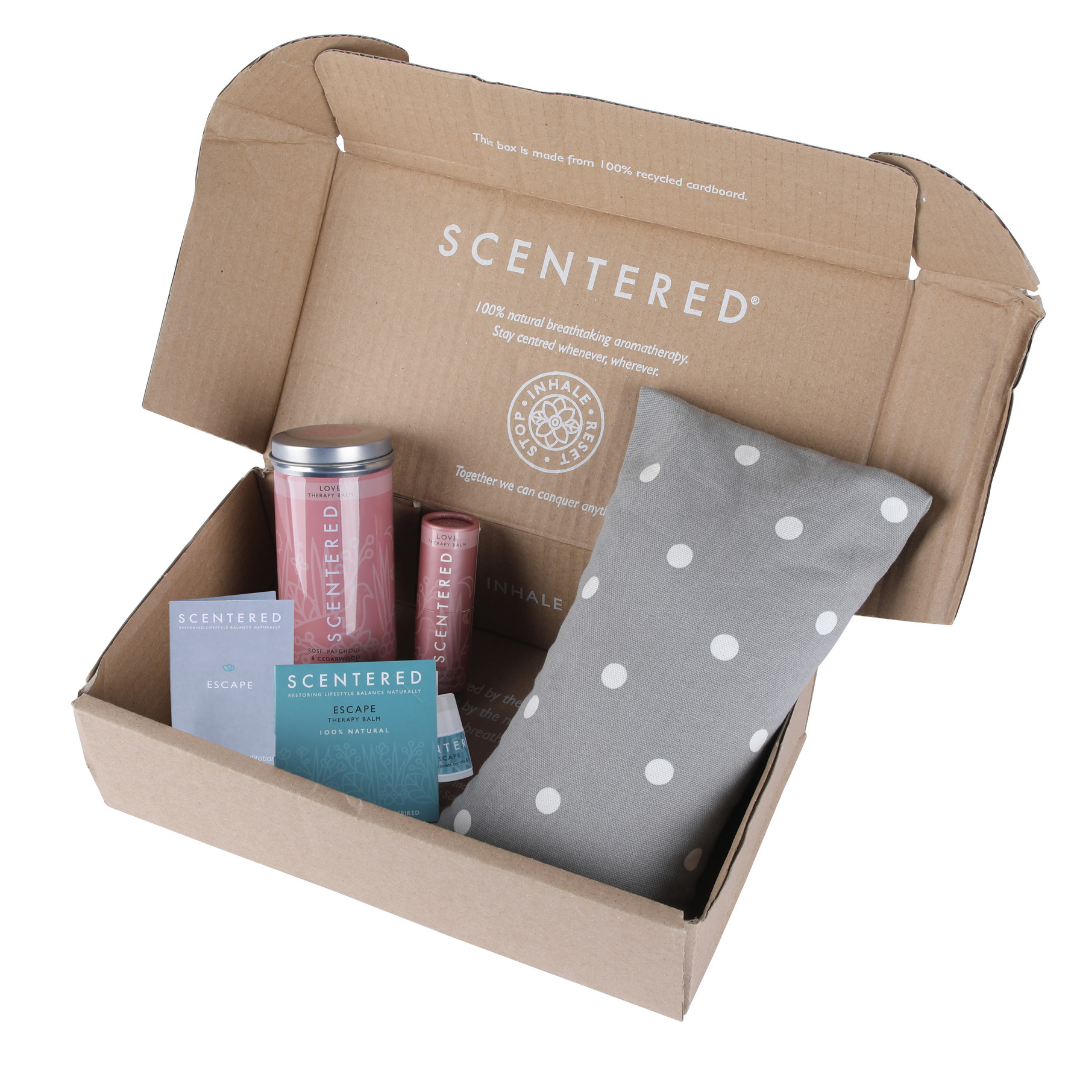 A Scentered branded box containing the Scentered Love Relaxation Set which includes a Love Balm, Wheat bag and Escape mini balm, on a white background. Love Therapy Balm by Scentered, a romantic floral blend crafted to inspire feelings of love and emotional connection. Meditation-enhancing aromatherapy balm by Scentered, featuring a calming blend of essential oils for a peaceful practice.