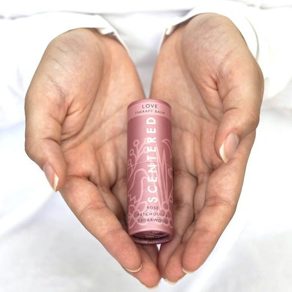 Scentered Love Aromatherapy Balm held in the palms of hands, love Therapy Balm by Scentered, a romantic floral blend crafted to inspire feelings of love and emotional connection.