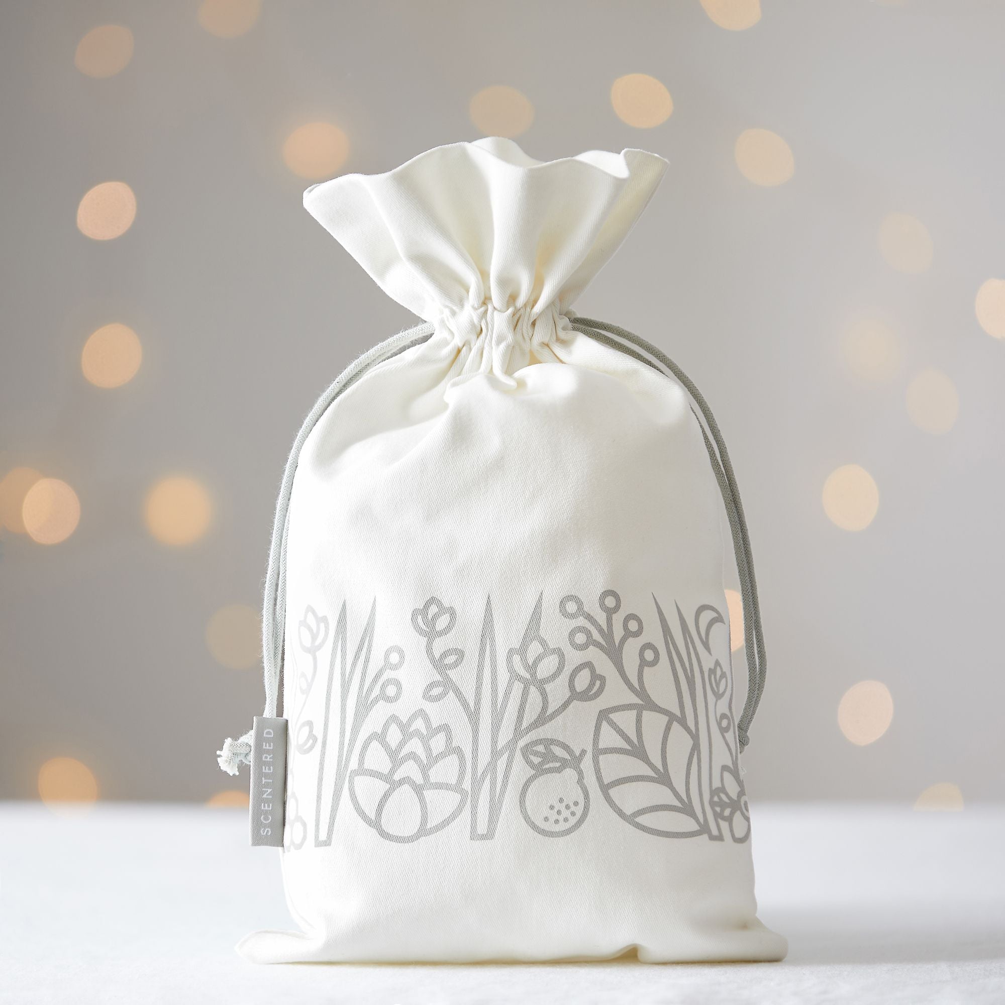 Reusable cotton drawstring bag, an eco-friendly alternative to traditional gift wrap, perfect for sustainable gifting.
