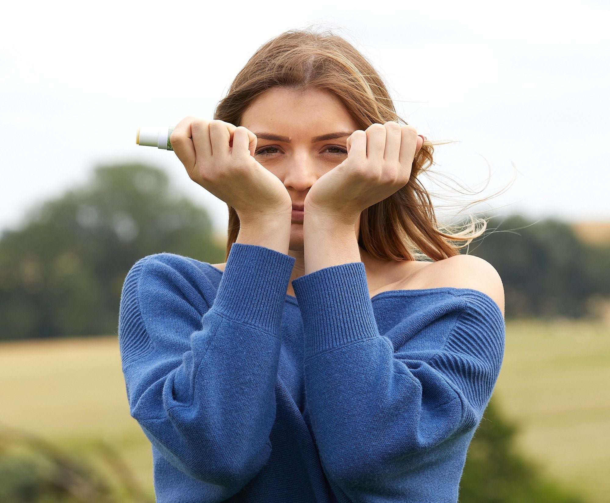 Girl_inhaling_Scentered_balm_aroma_from_pulse_point_on_wrists