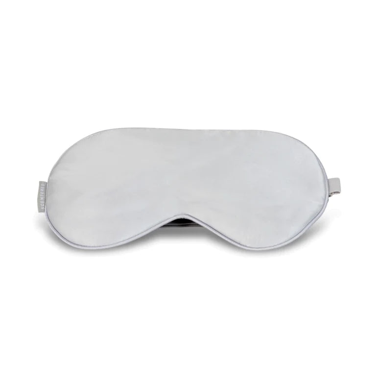 Silvery grey silk eye mask with a soft-touch finish and adjustable strap for personalized comfort. Our super soft Eye Mask will block out any unwanted light, helping you to switch off from the day and transition into a deep slumber. Combine with our sleep well Balm and Candle for the ultimate restful night's sleep.