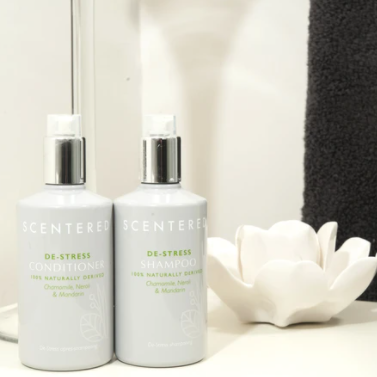 Scentered De-stress Shampoo and Conditioner in bathroom setting. Restorative Shampoo and Conditioner for Calm and Clean Hair.