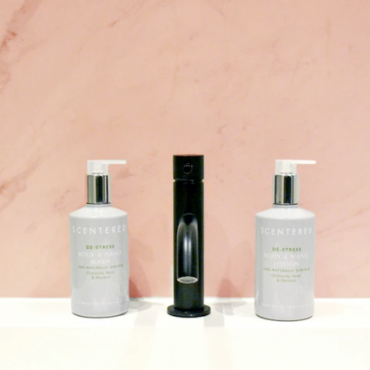 De-stress Wash and Lotion bottles next to sink faucet. Organic Aloe Body Wash & Jojoba Oil Lotion for Relaxation.
